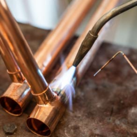 Nashville plumber from ALL PIPES skillfully welding copper piping